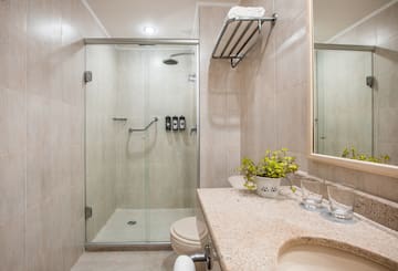 a bathroom with a glass shower and sink
