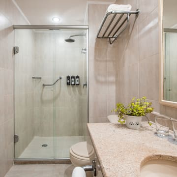 a bathroom with a glass shower and sink