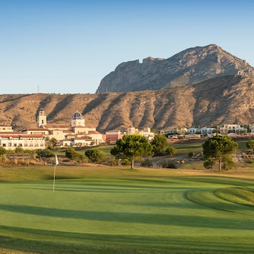 a golf course with a mountain in the background