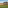 Mediterranean golf resort with village architecture and rugged mountains.