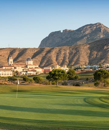 a golf course with a mountain in the background