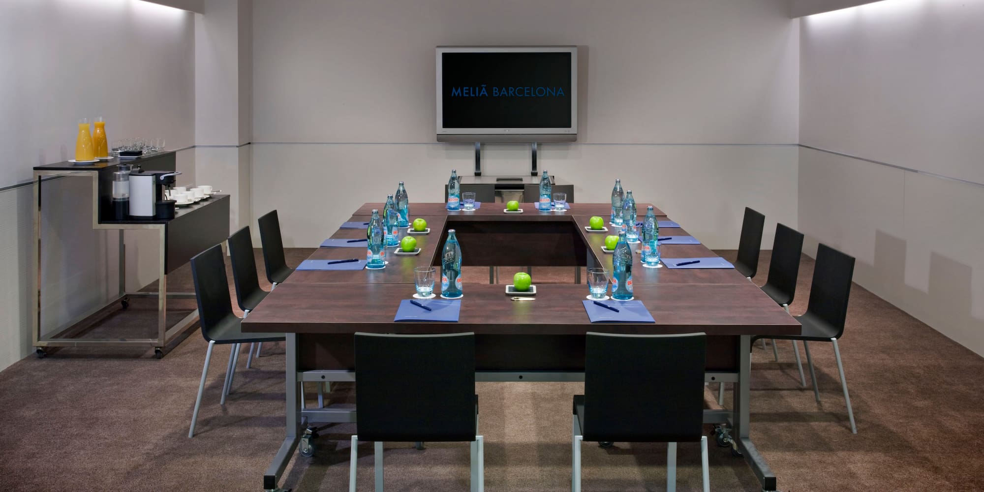 a conference room with a table and chairs