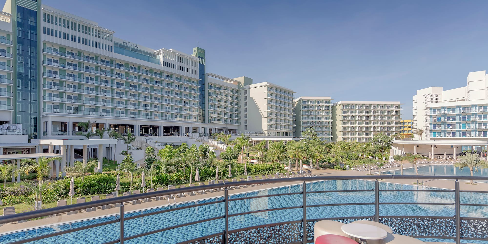 a pool with a large building in the background