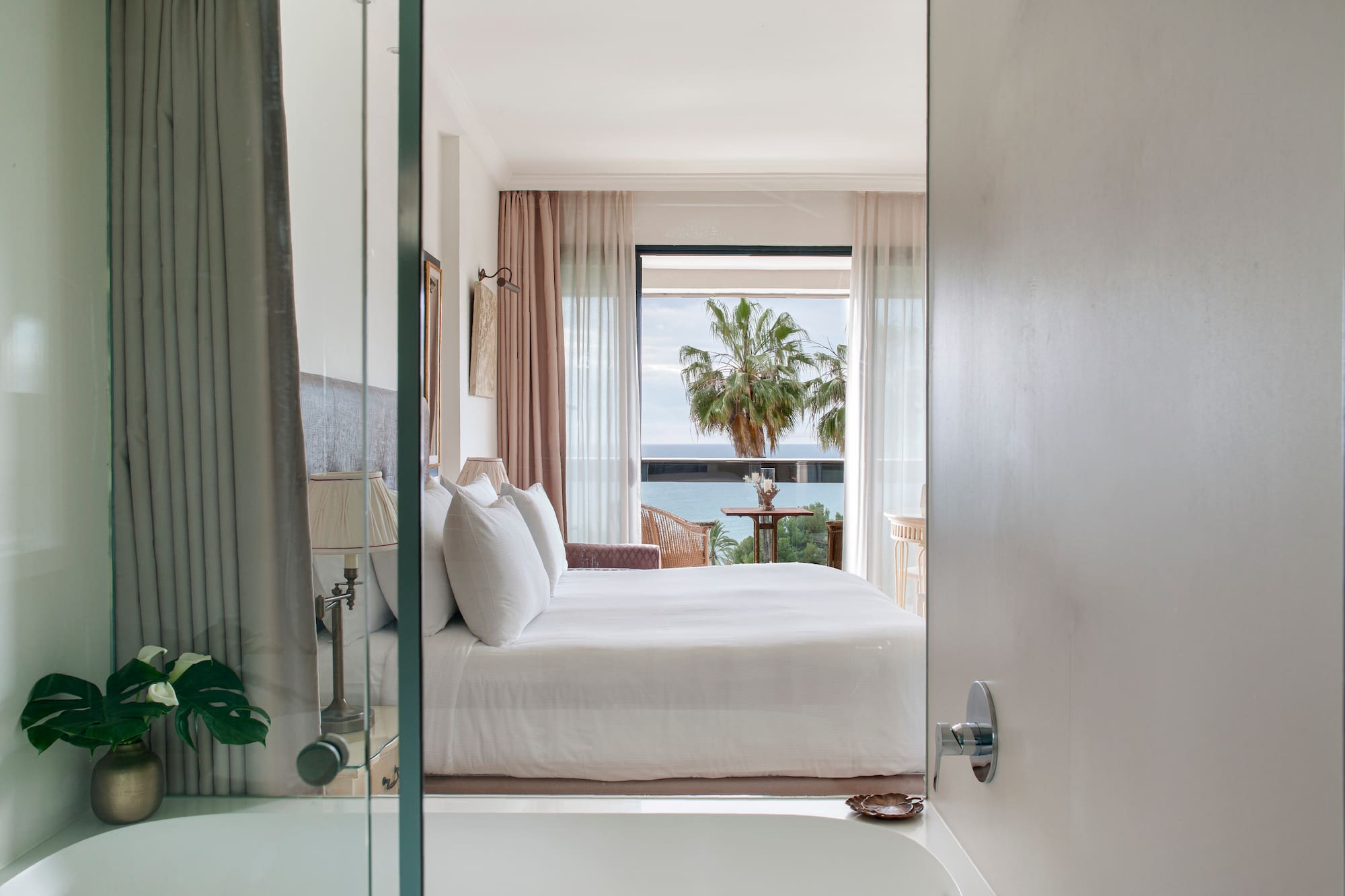 a bedroom with a bathtub and a bed