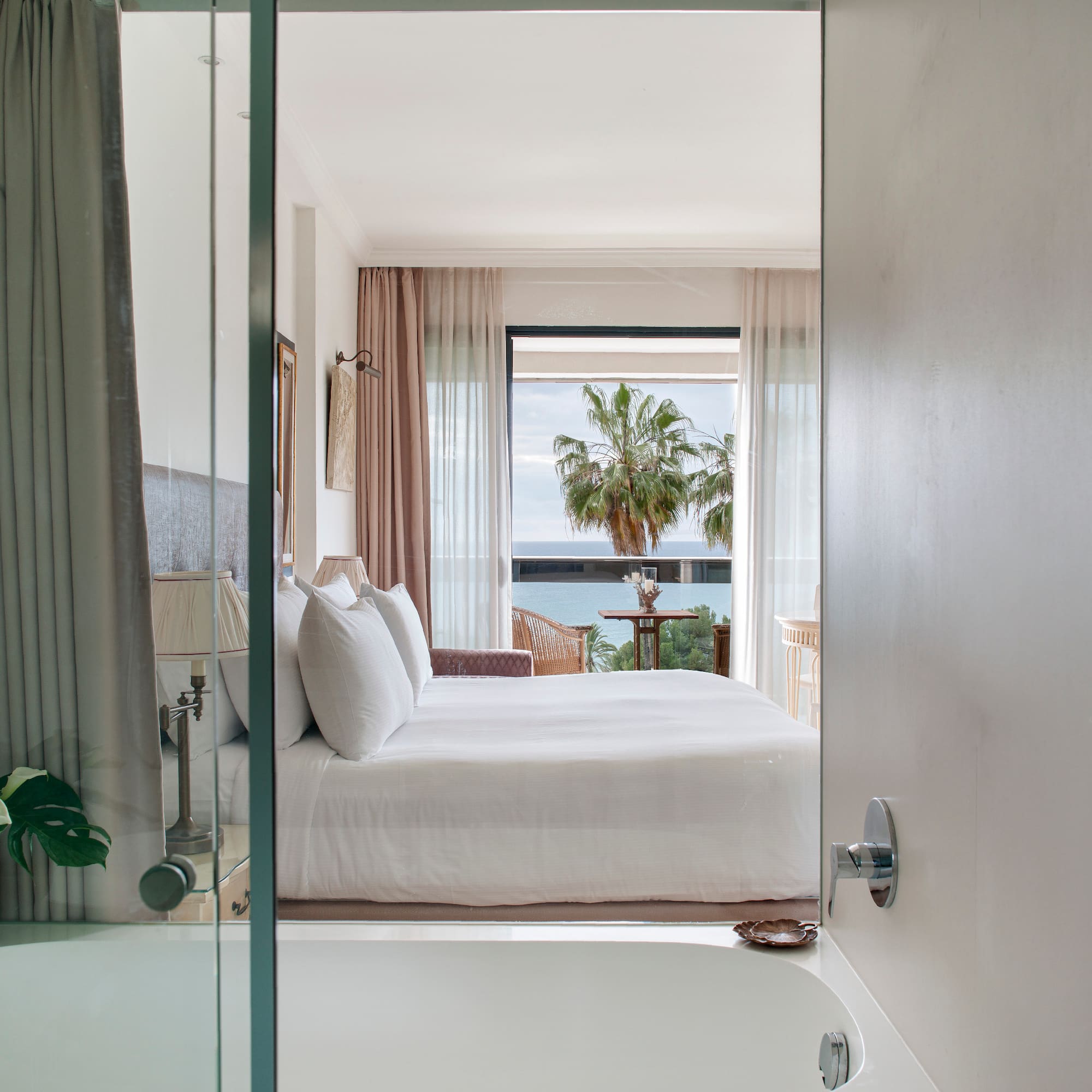 a bedroom with a bathtub and a bed