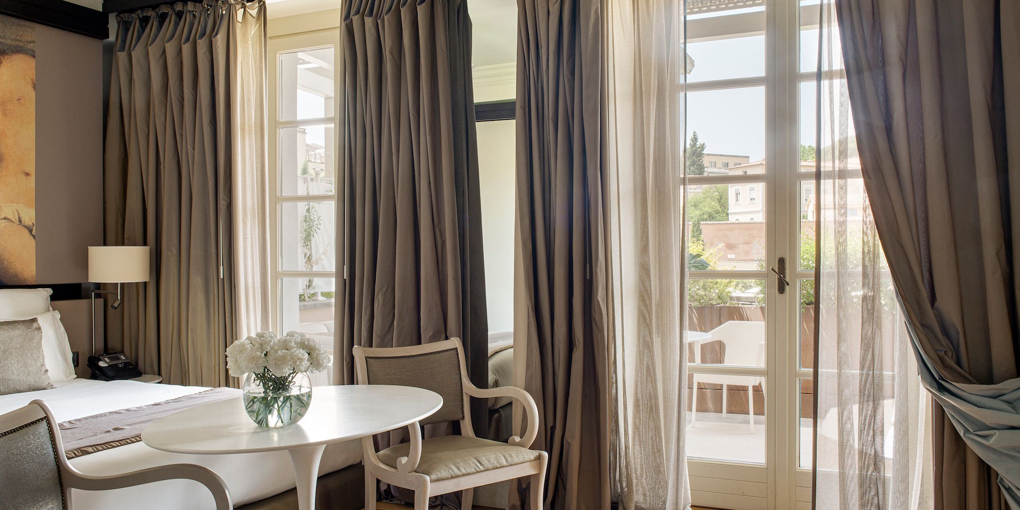 a room with a bed and chairs and a table