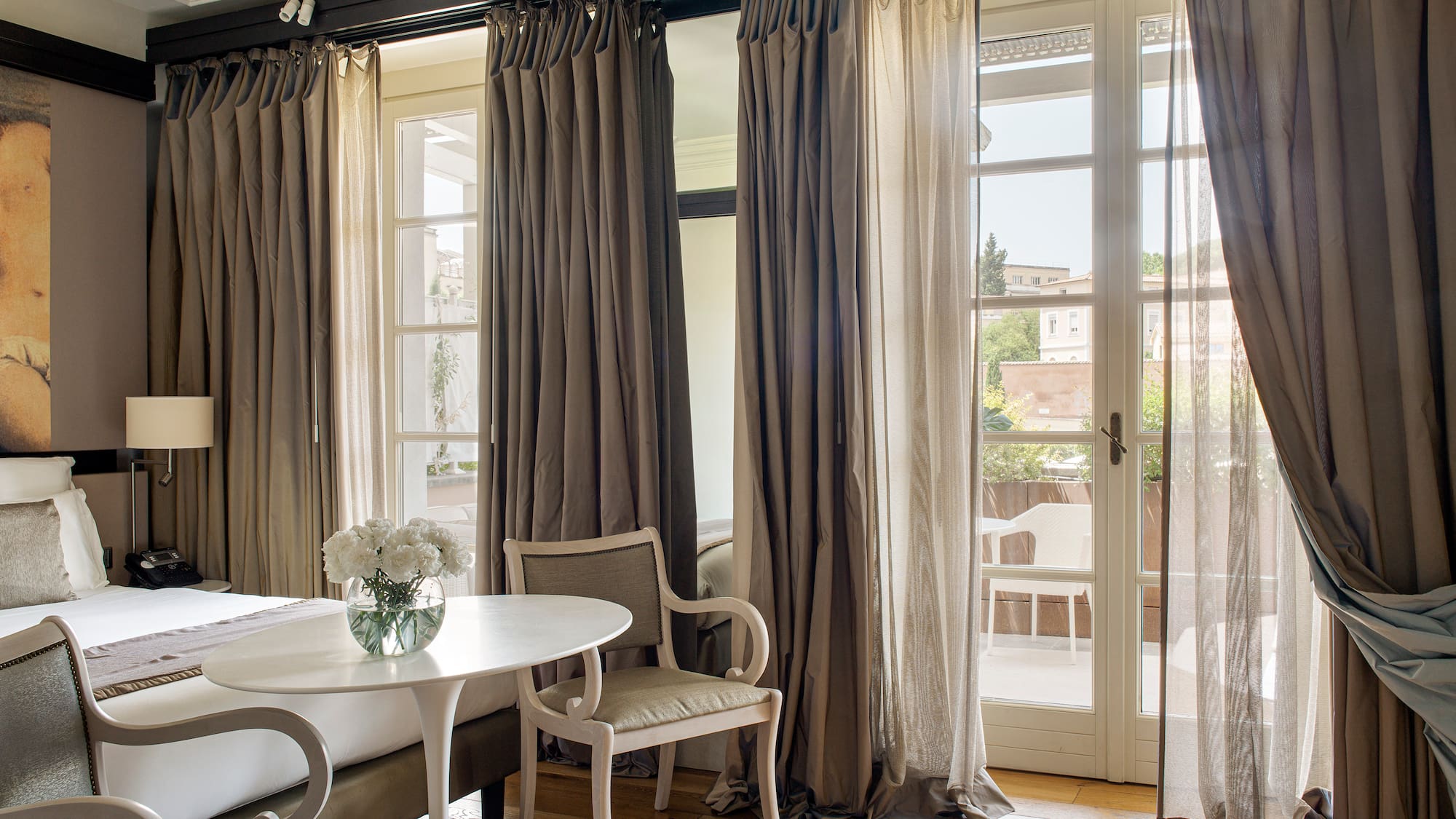 a room with a bed and chairs and a table