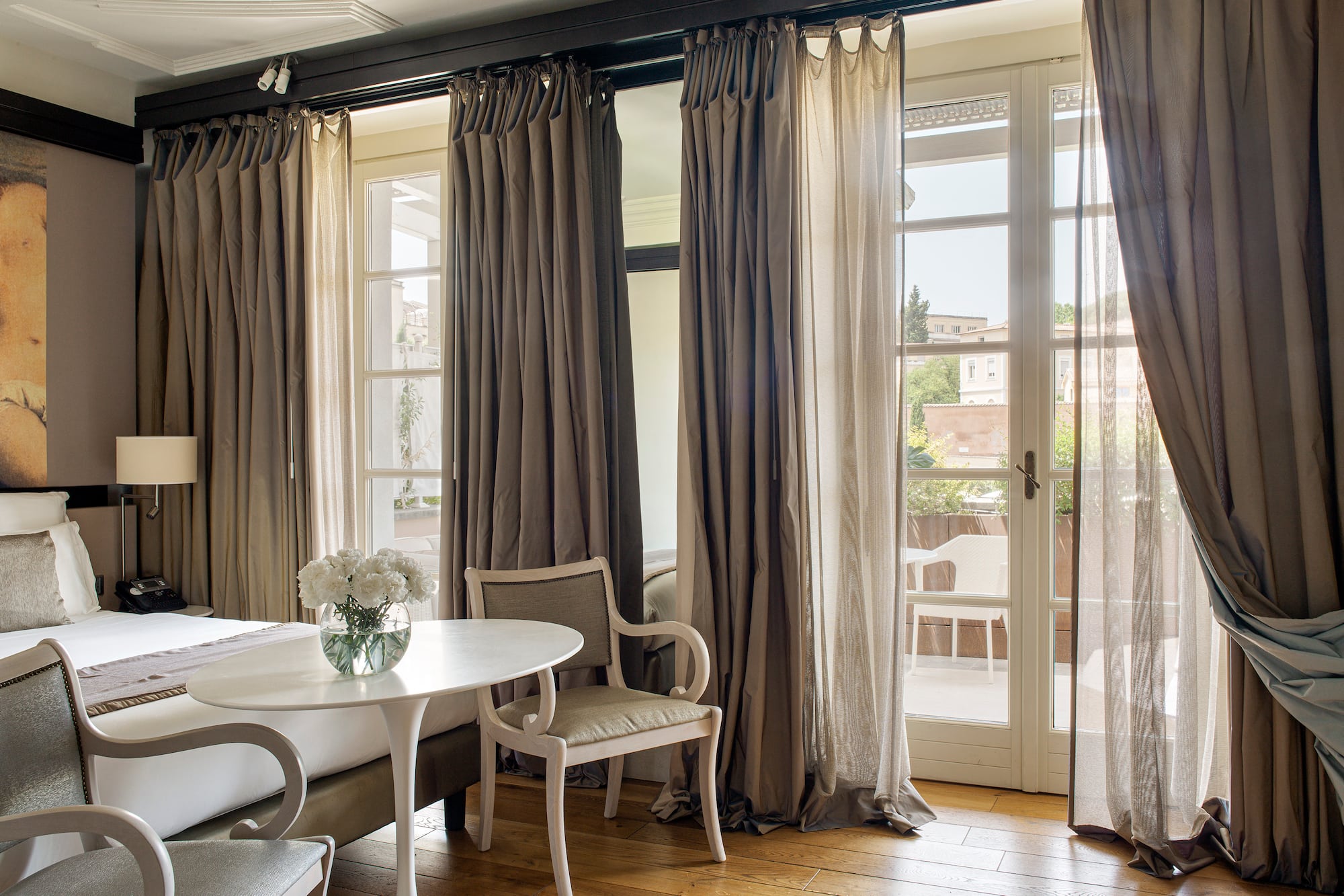 a room with a bed and chairs and a table