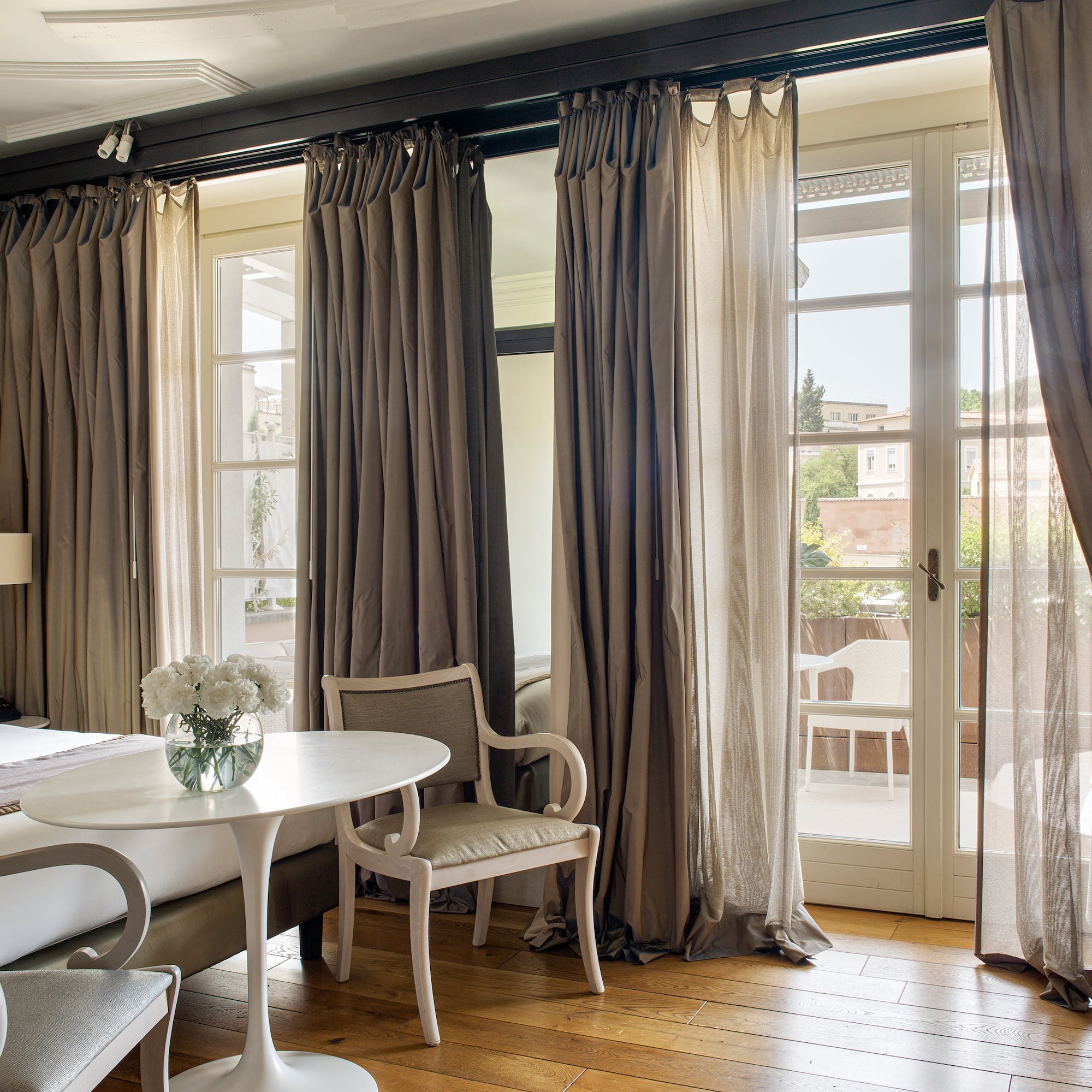 a room with a bed and chairs and a table