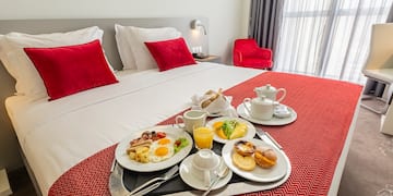 a tray of breakfast on a bed