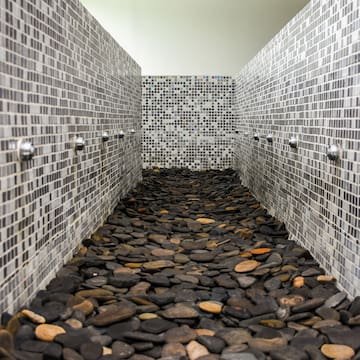 a shower with a group of rocks on the floor