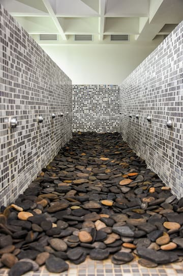 a shower with a group of rocks on the floor