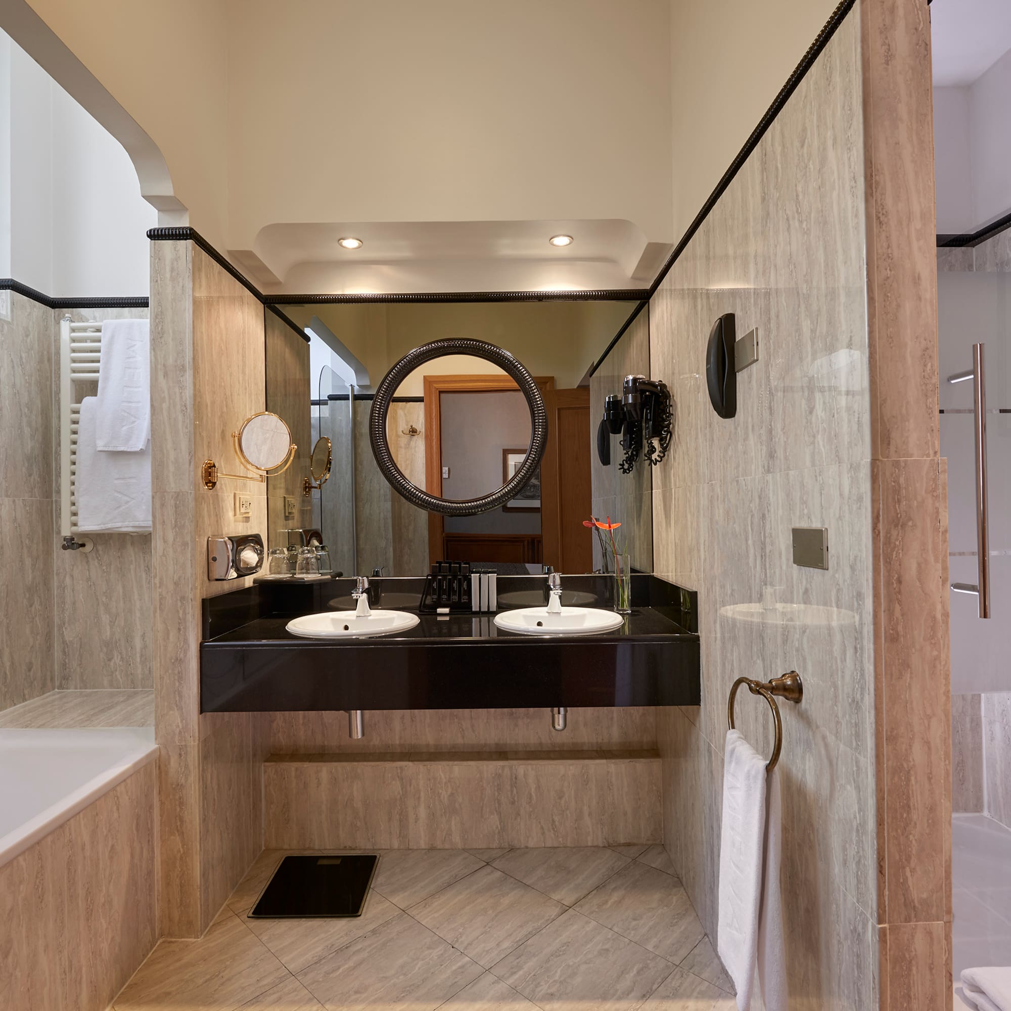 a bathroom with marble walls and a sink