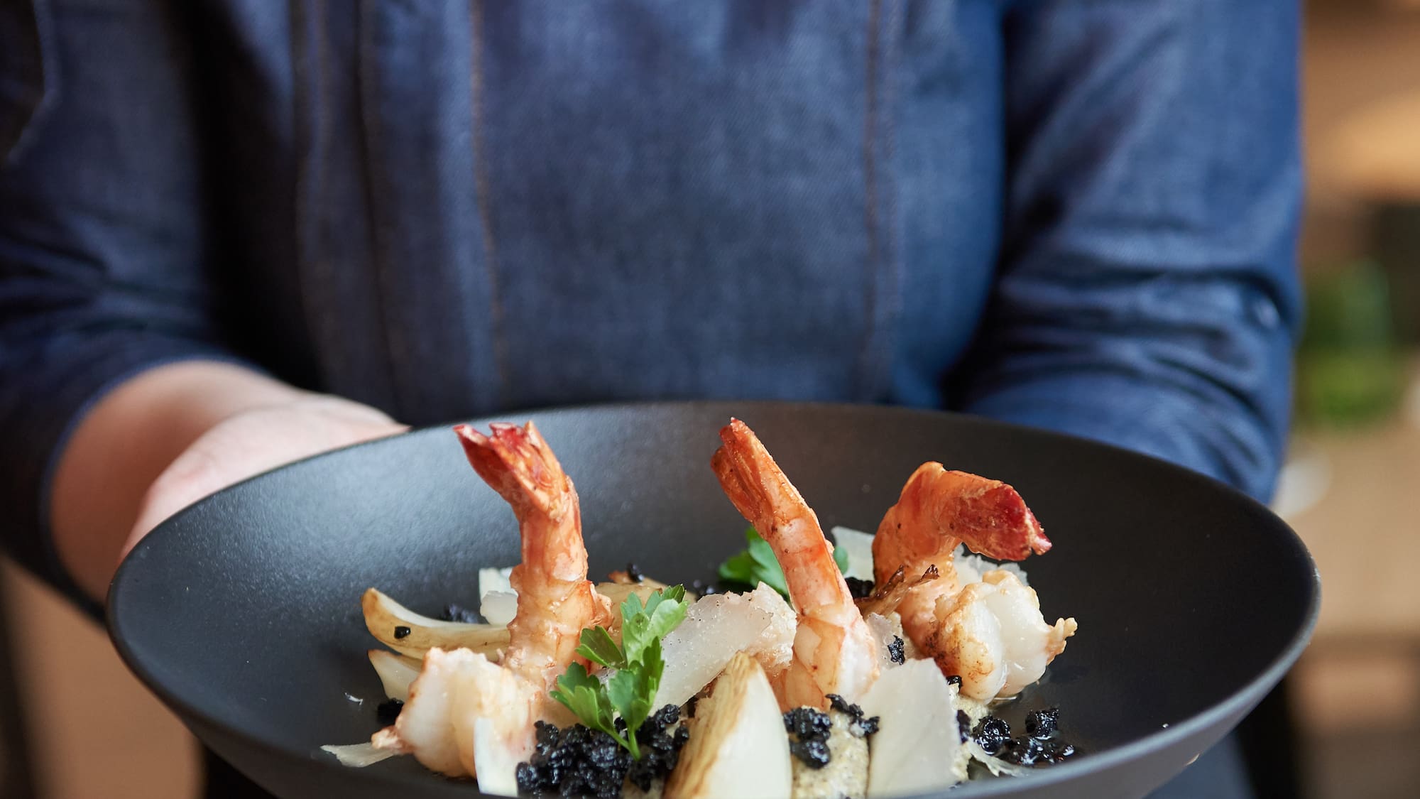 a person holding a plate of food