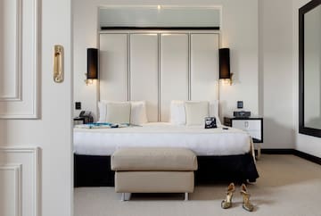 a bedroom with a bed and shoes on the wall