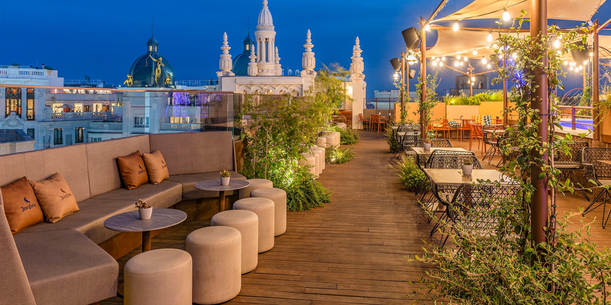a patio with tables and chairs on a rooftop