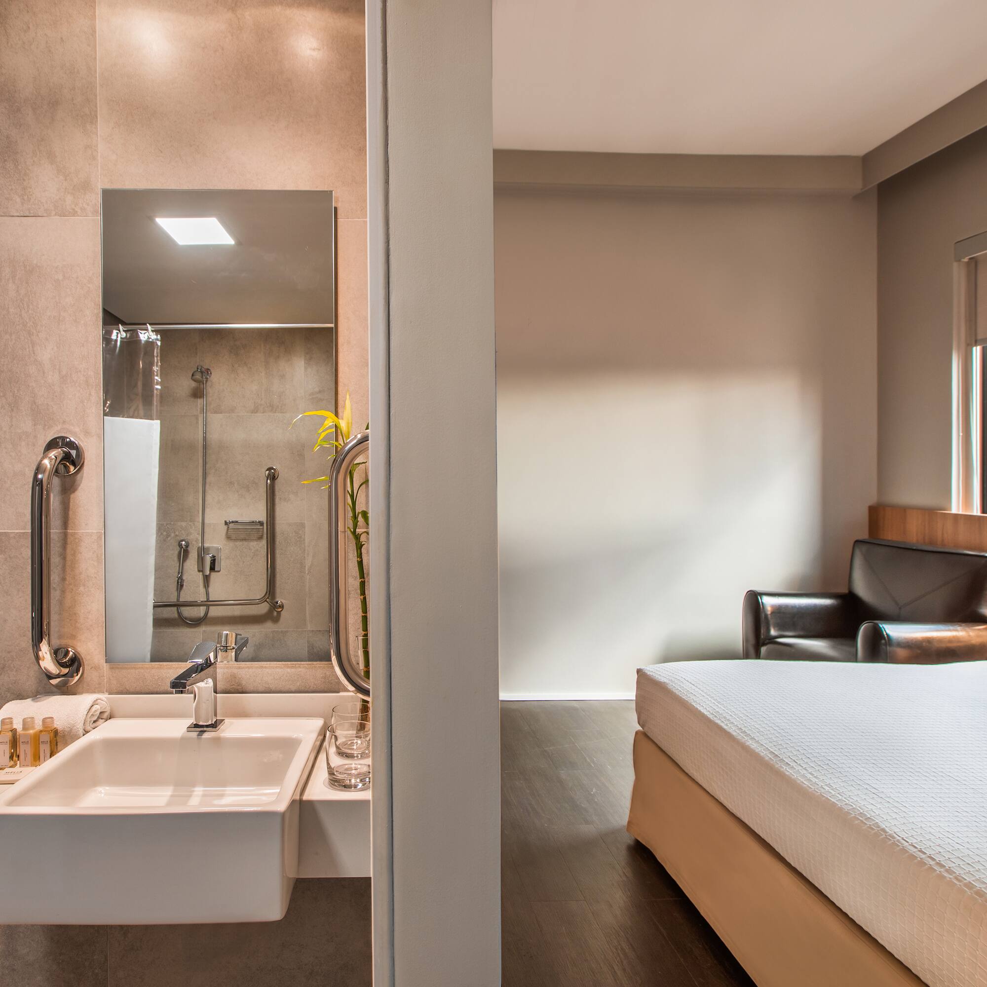 a bathroom with a bed and sink