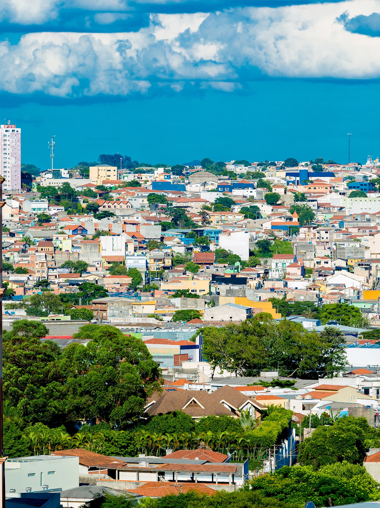 a tall building with a gold roof and a city landscape