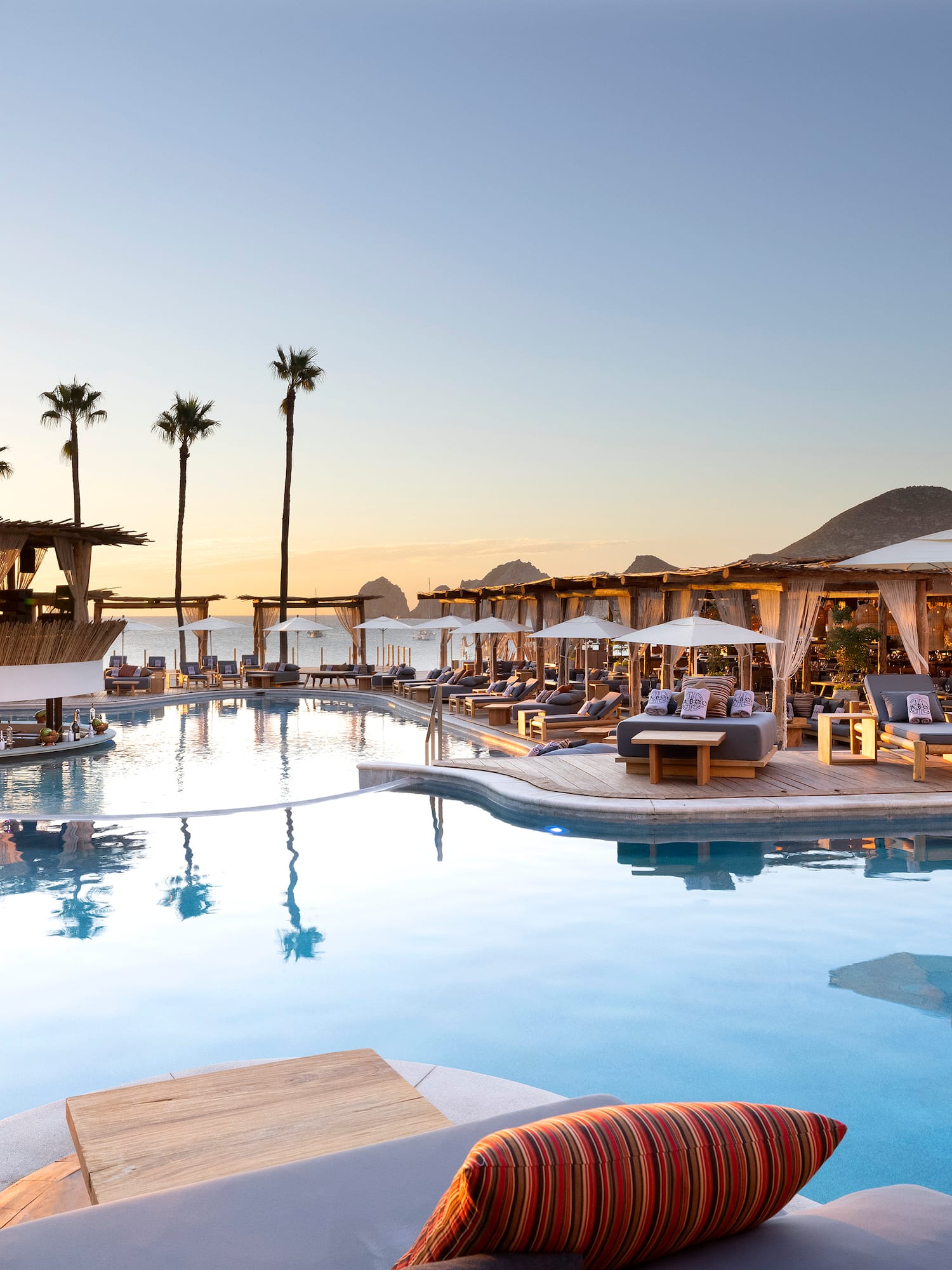 a pool with lounge chairs and umbrellas