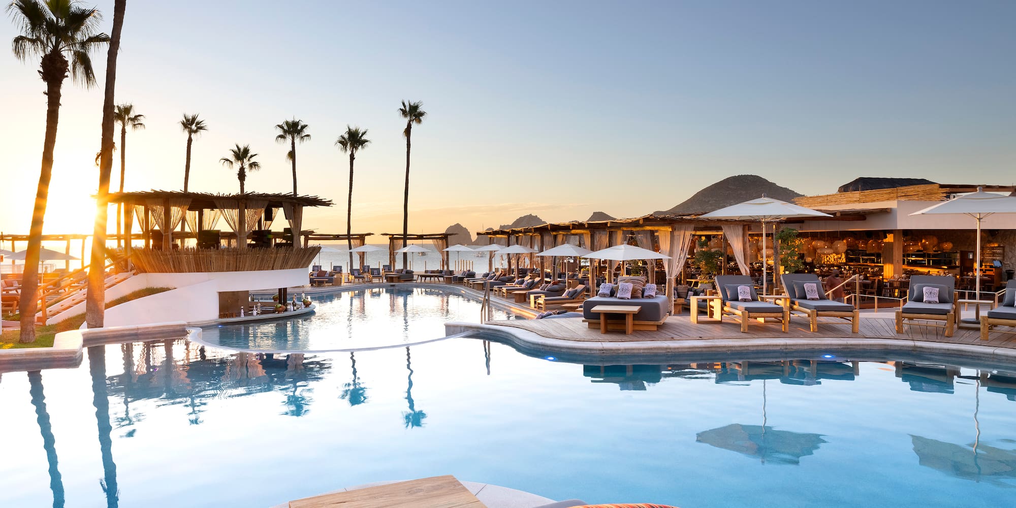 a pool with lounge chairs and umbrellas