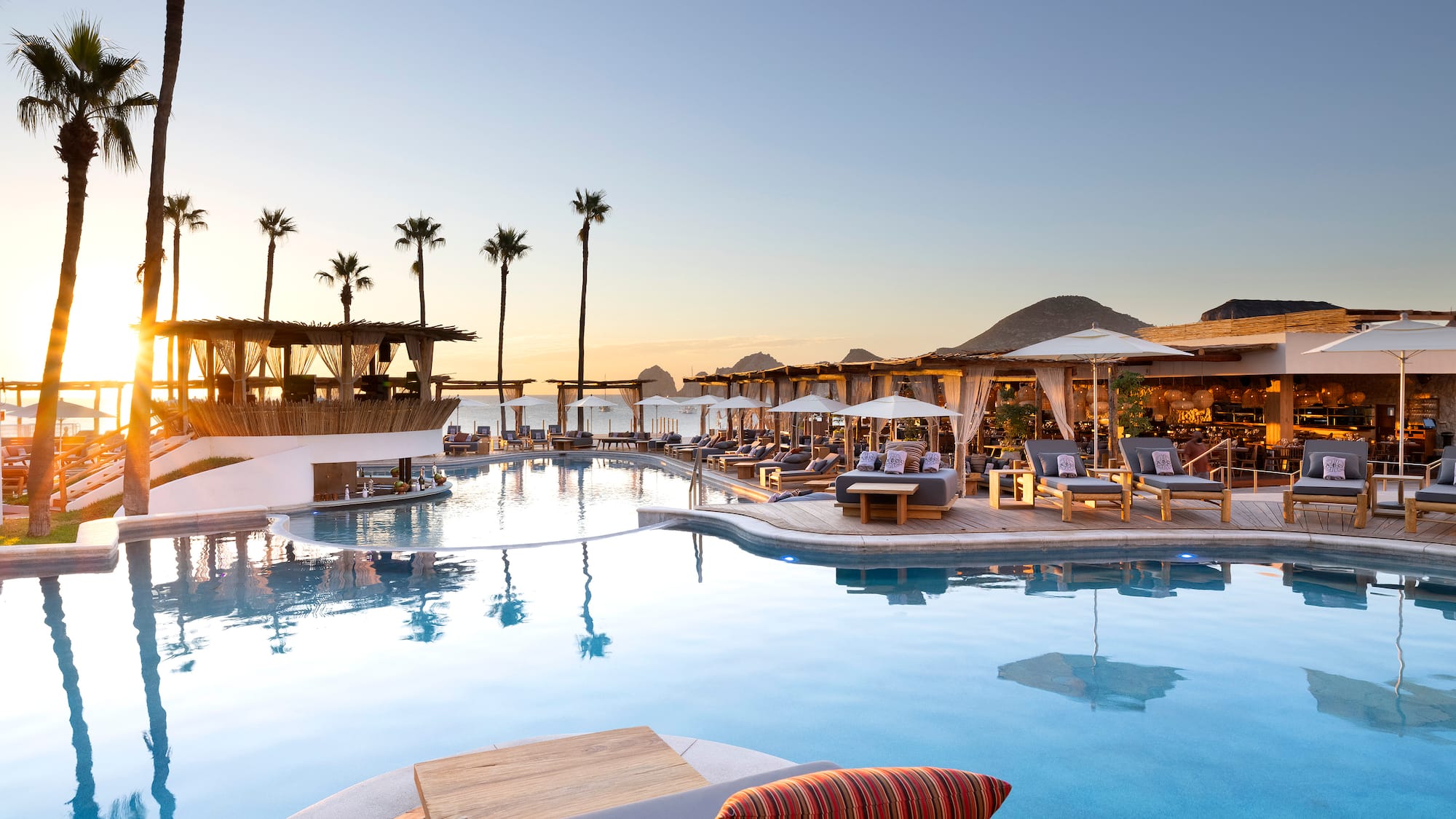 a pool with lounge chairs and umbrellas