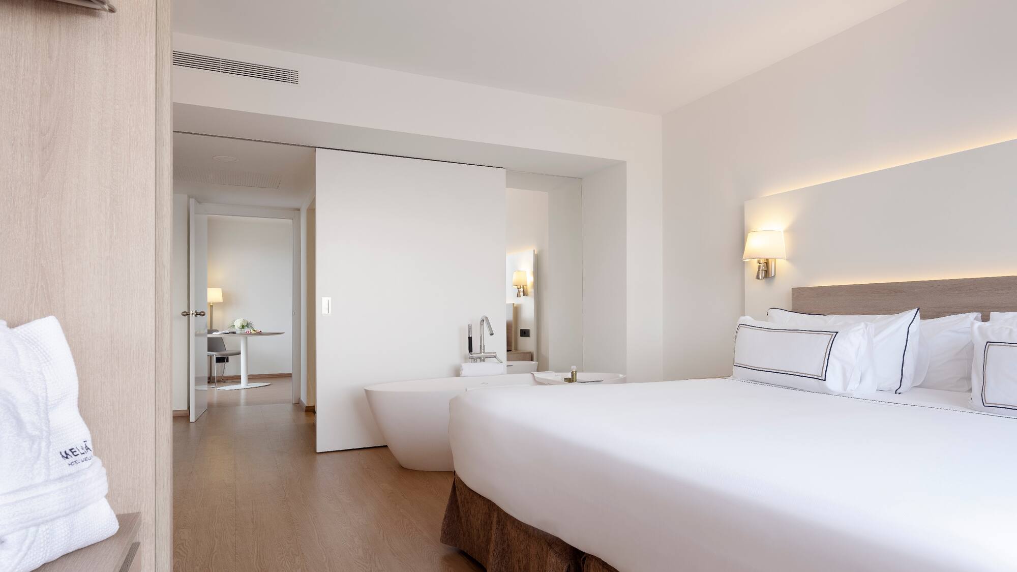 a bedroom with a large bed and bathtub