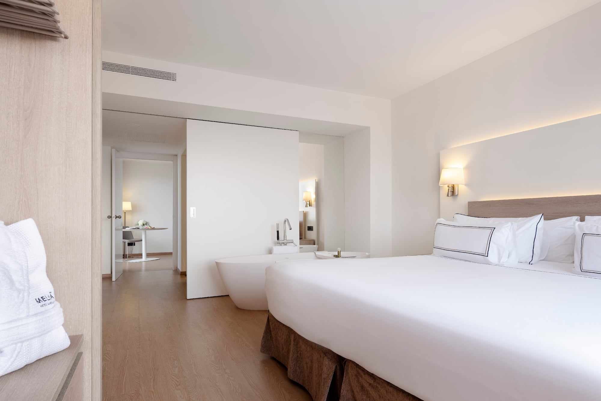 a bedroom with a large bed and bathtub