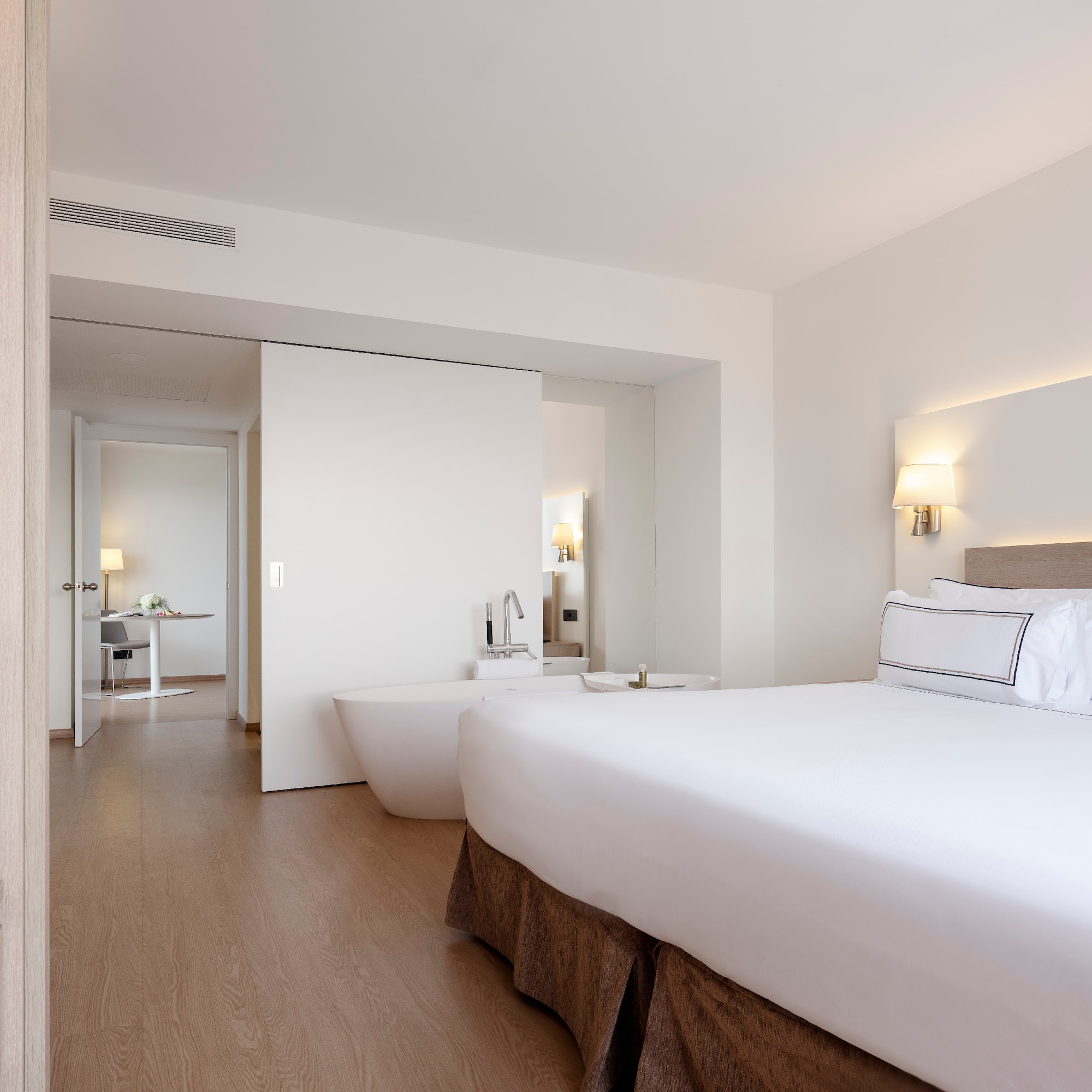 a bedroom with a large bed and bathtub