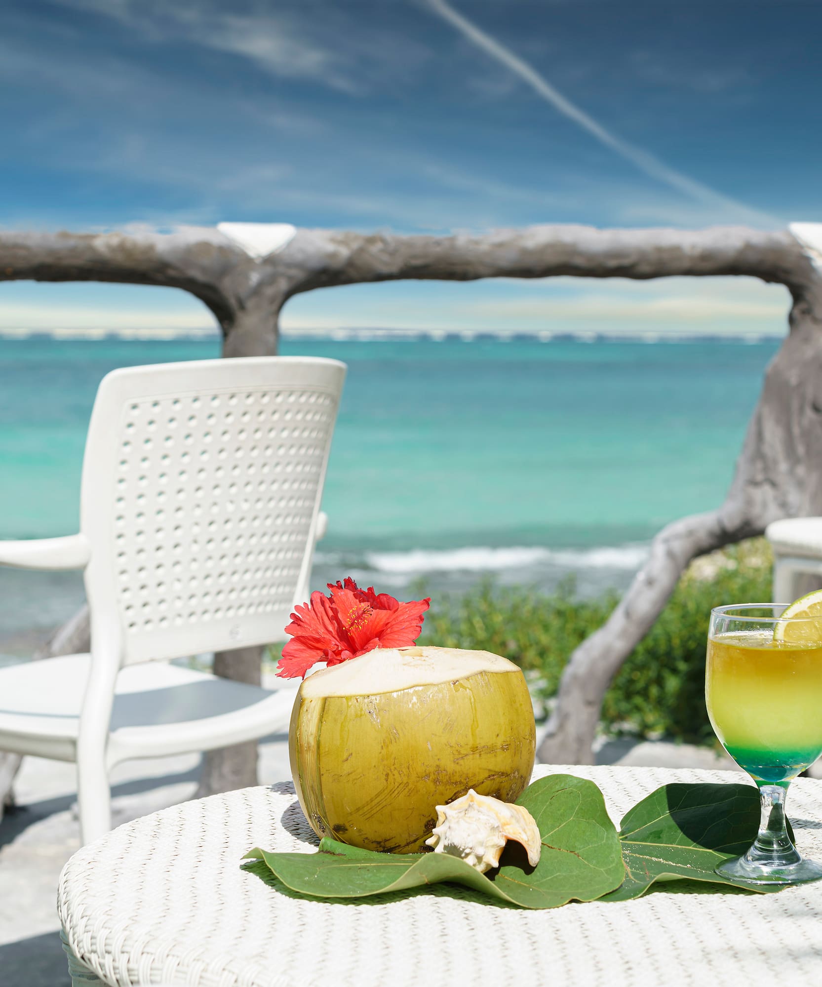 a table with a drink on it and a coconut on it
