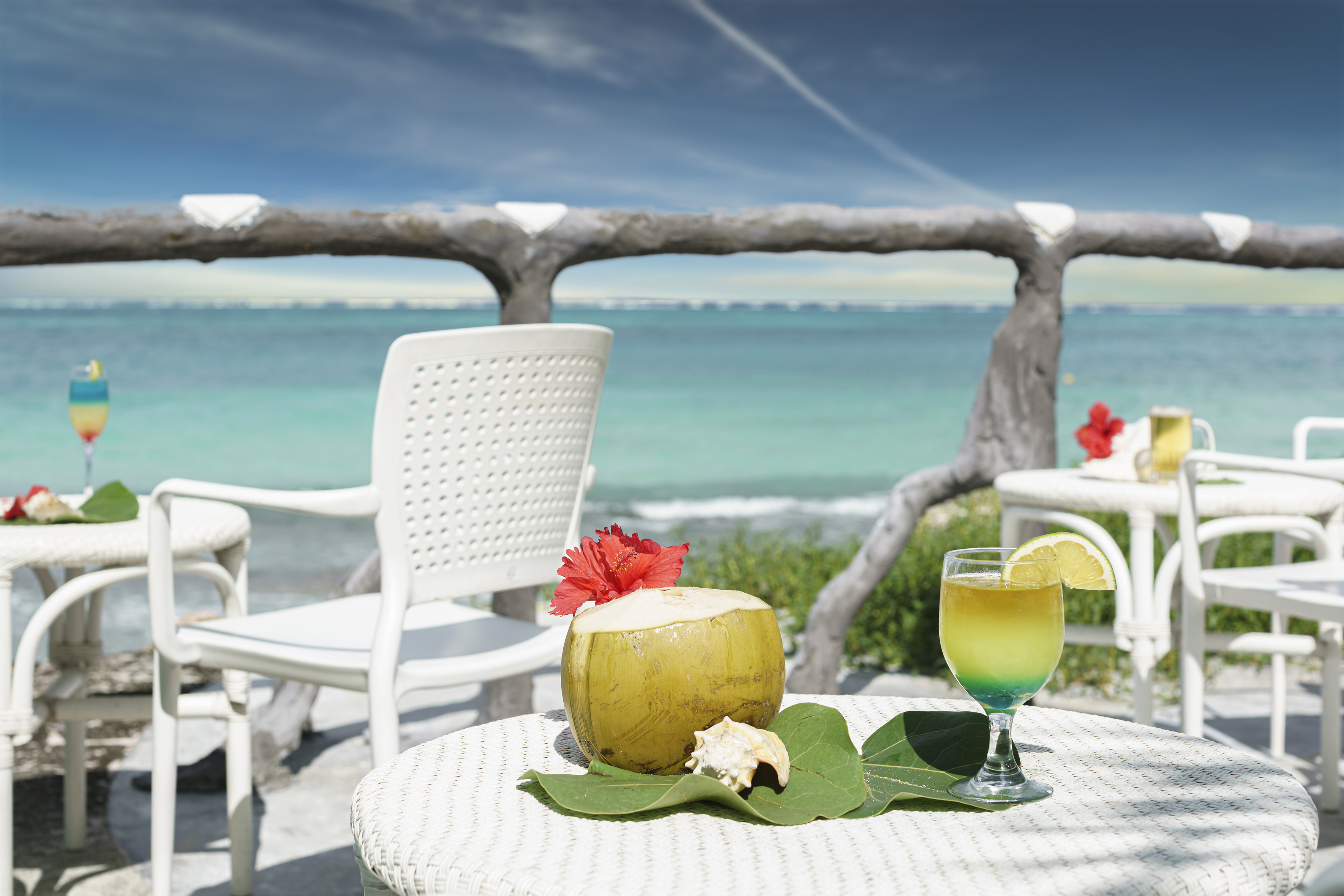 a table with a drink on it and a coconut on it