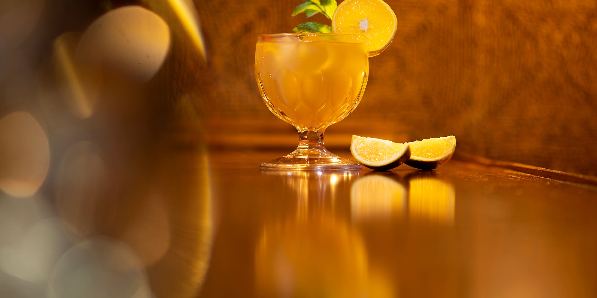 a glass with a drink and lemon slices on it