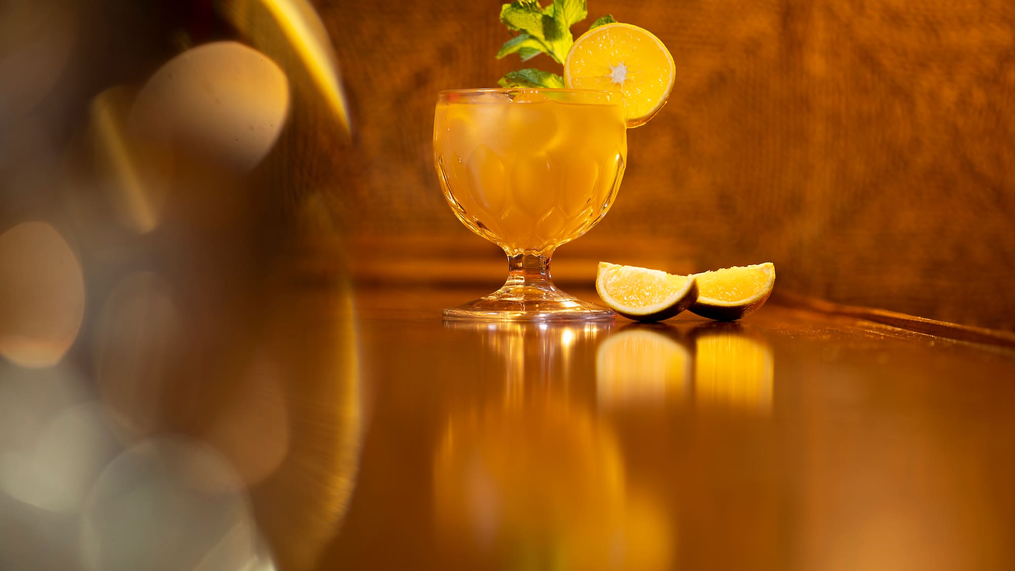 a glass with a drink and lemon slices on it