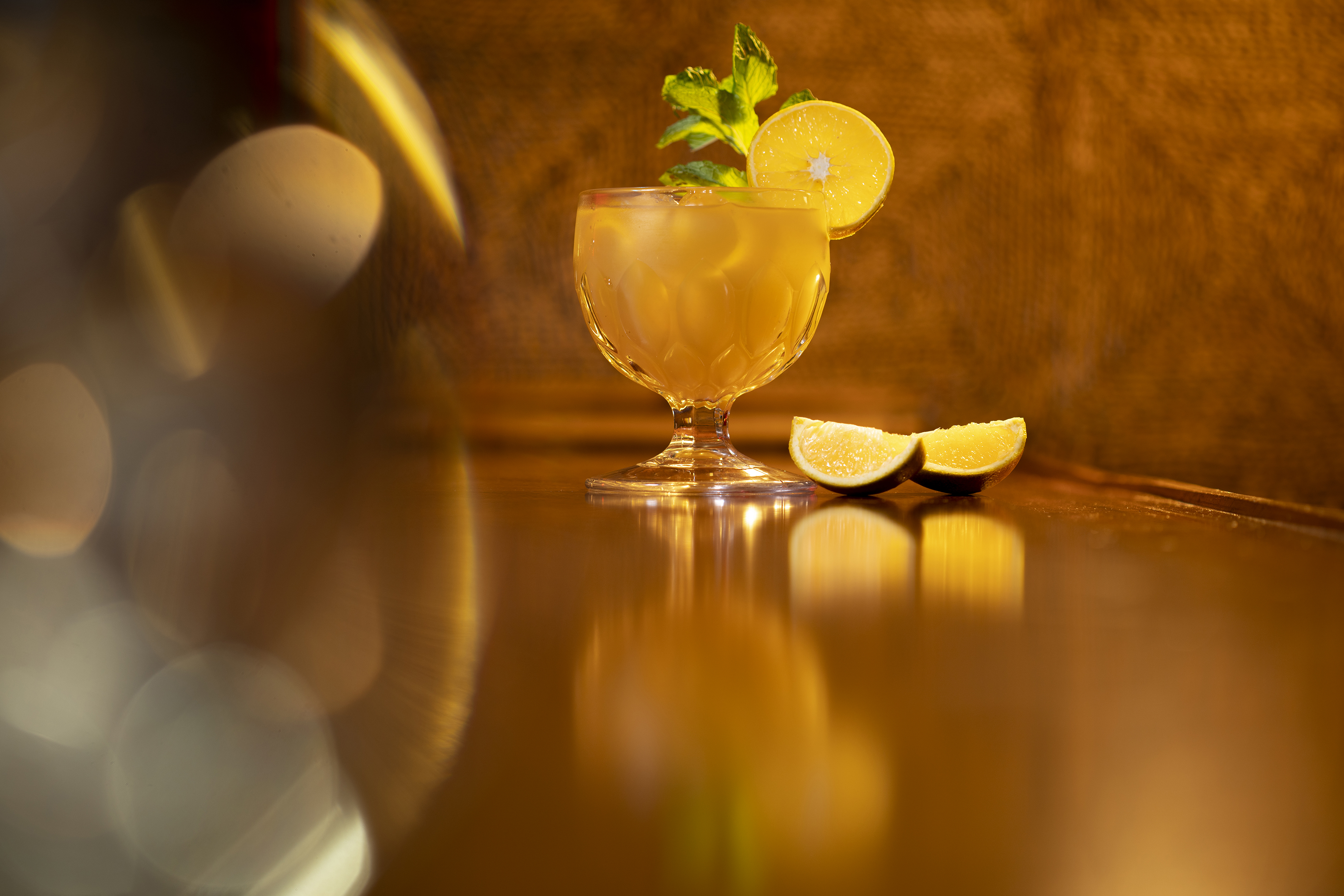 a glass with a drink and lemon slices on it