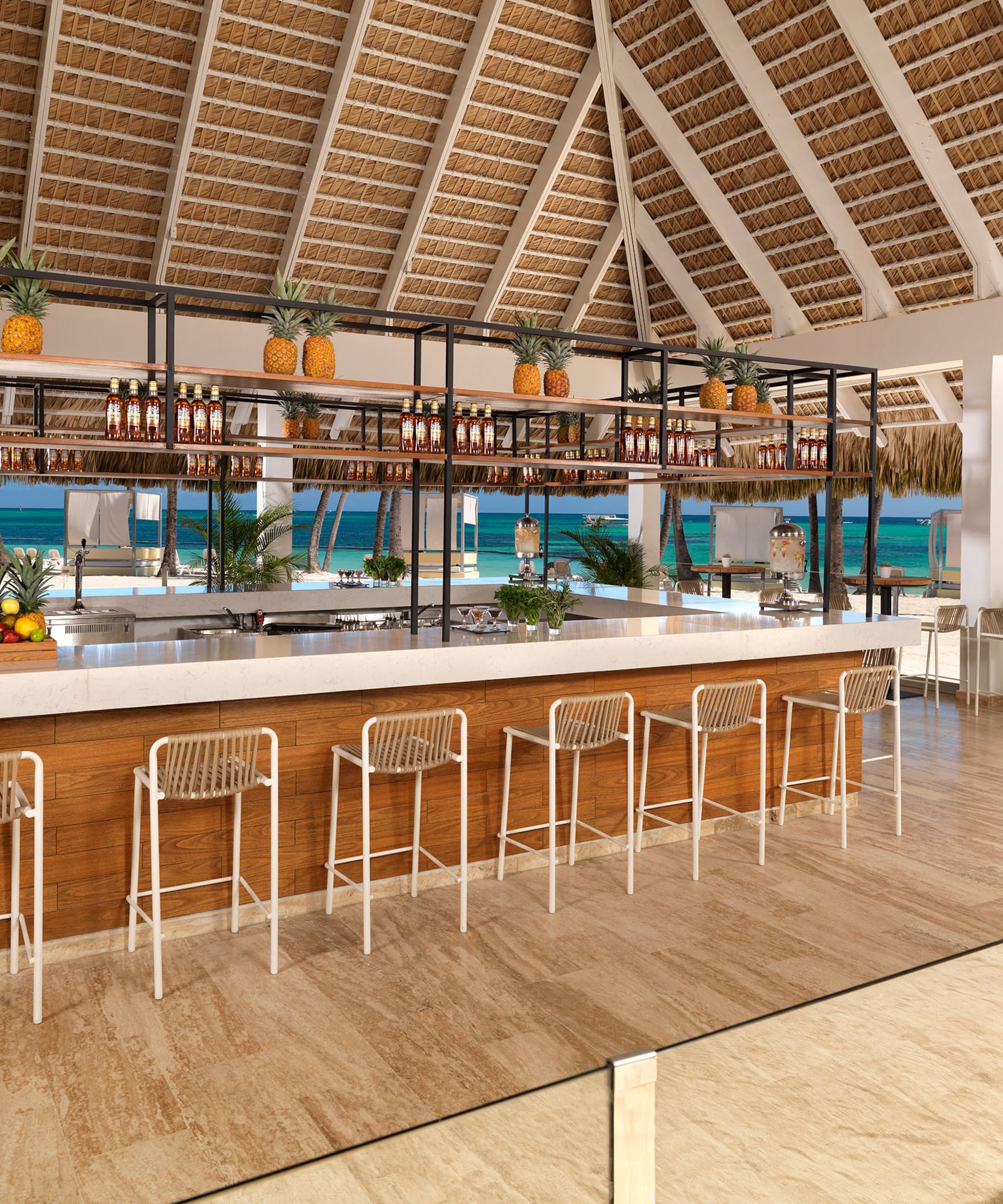 a bar with a shelf and chairs in a tropical setting