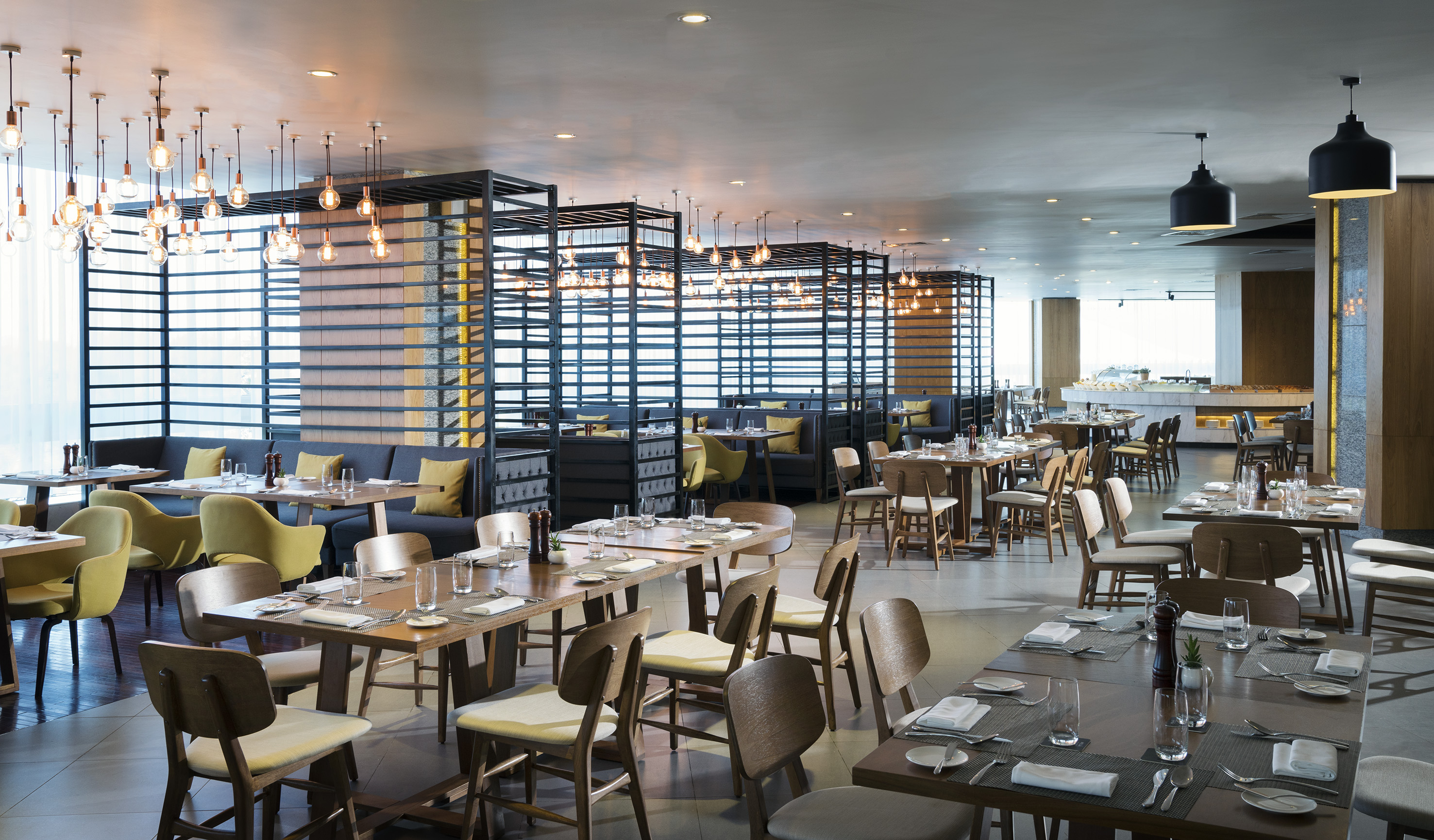 Modern restaurant dining room with varied seating and ambient lighting.