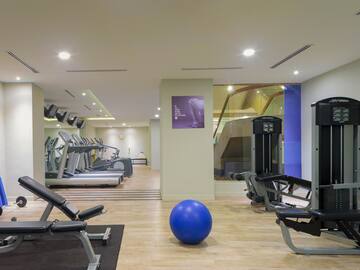 a room with exercise equipment and a blue ball