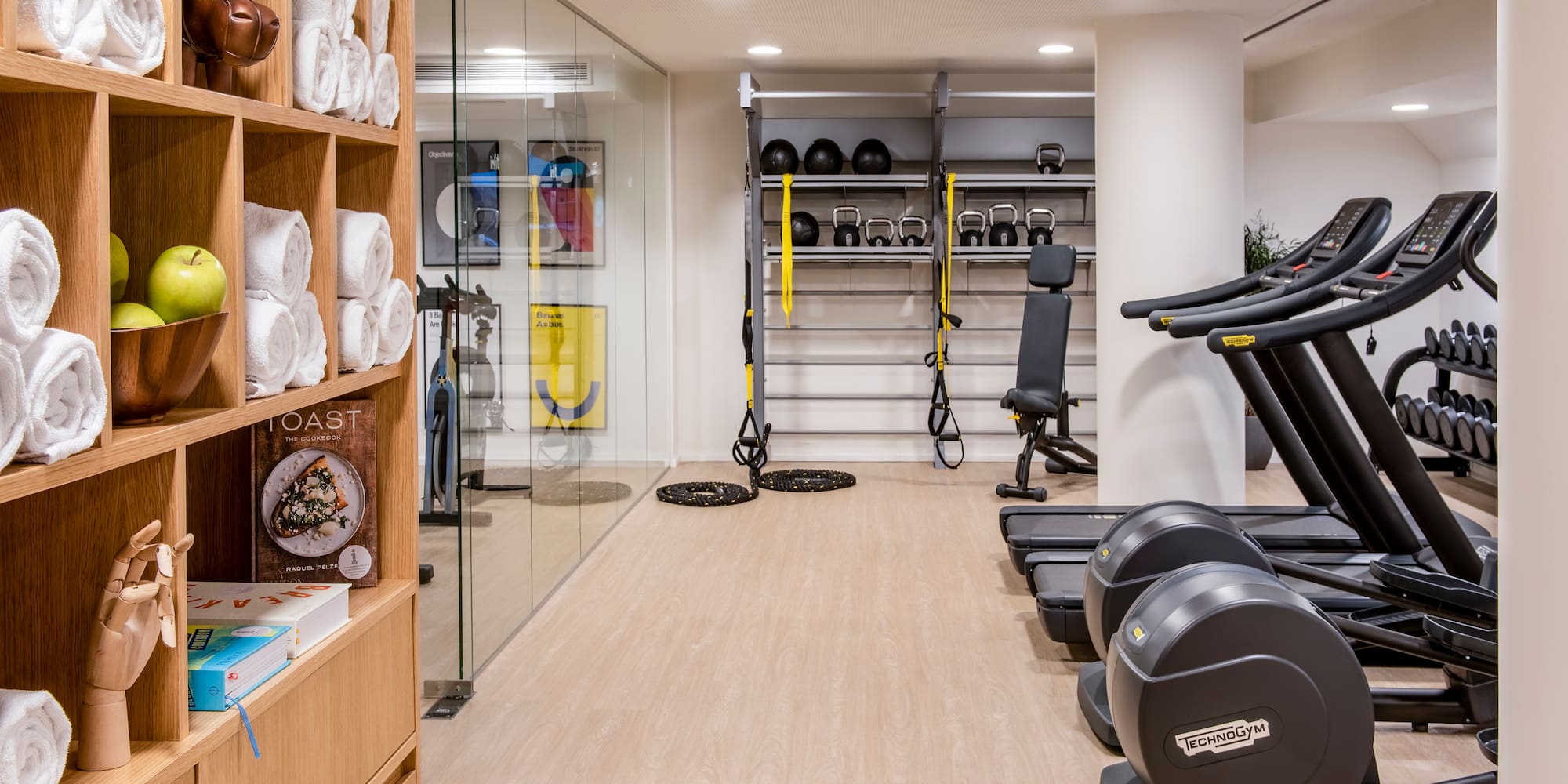 a room with exercise equipment and shelves with other objects