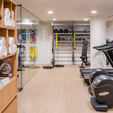 a room with exercise equipment and shelves with other objects