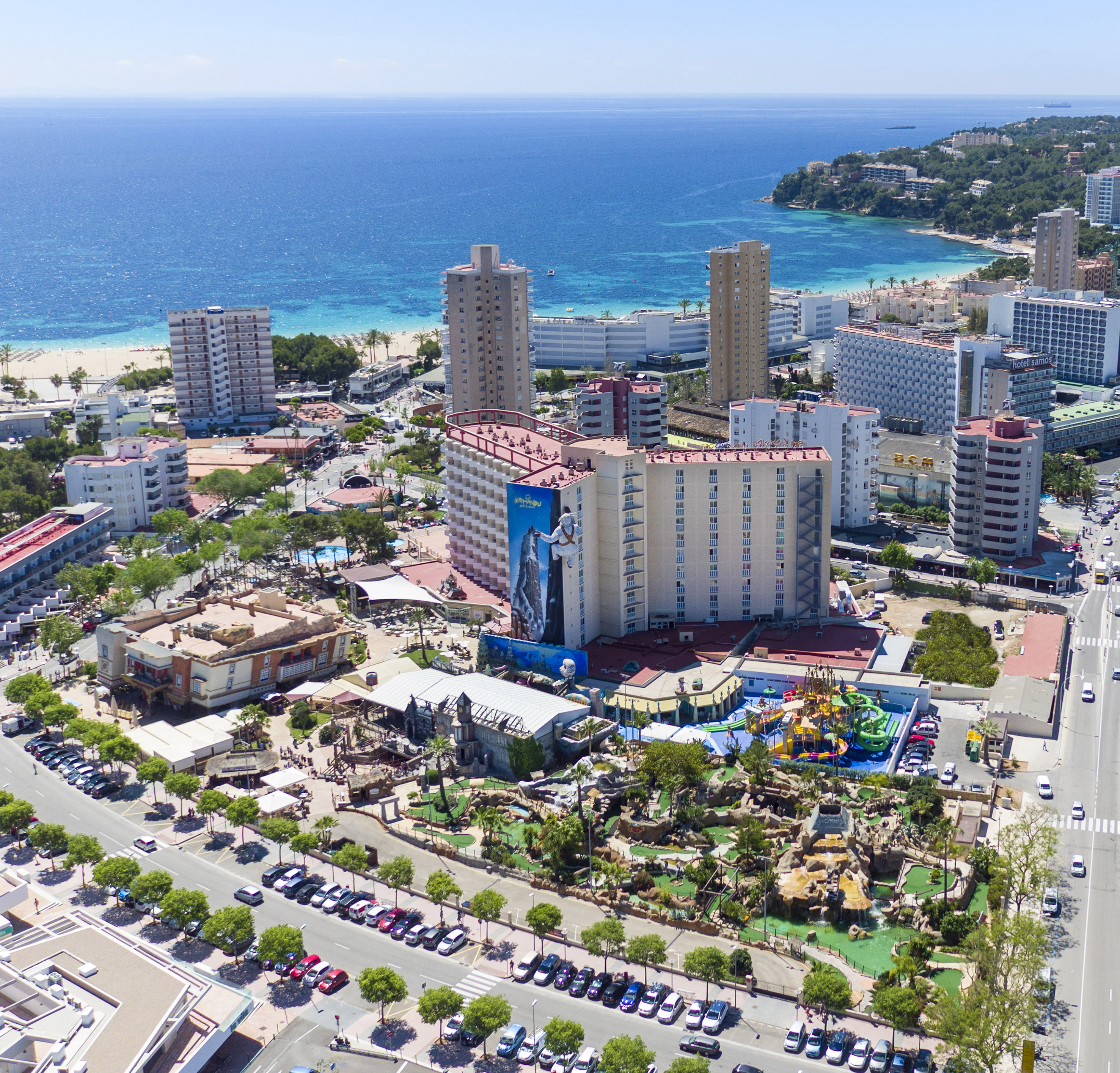 Aerial view of Magaluf, Mallorca: beach, resort hotels, water park, and mini golf.