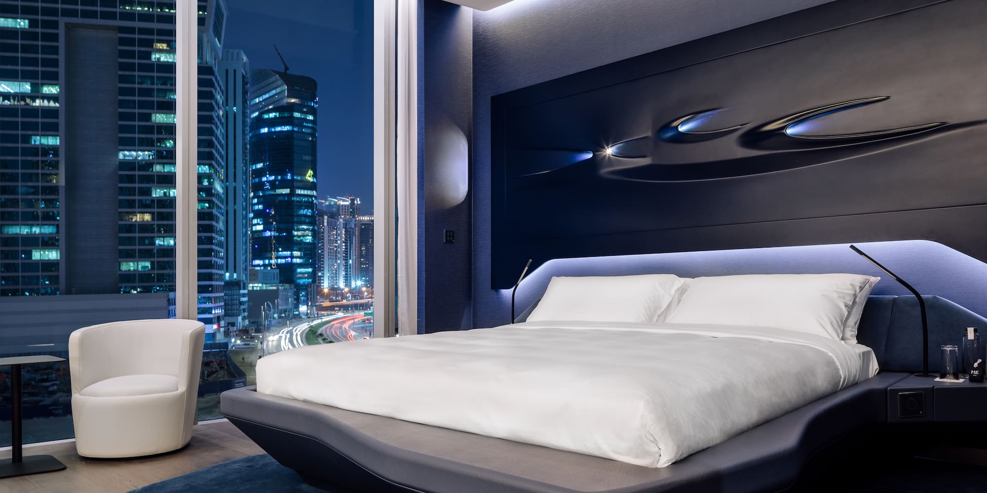 a bedroom with a large window and a large bed