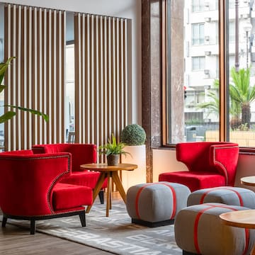 a room with red chairs and tables