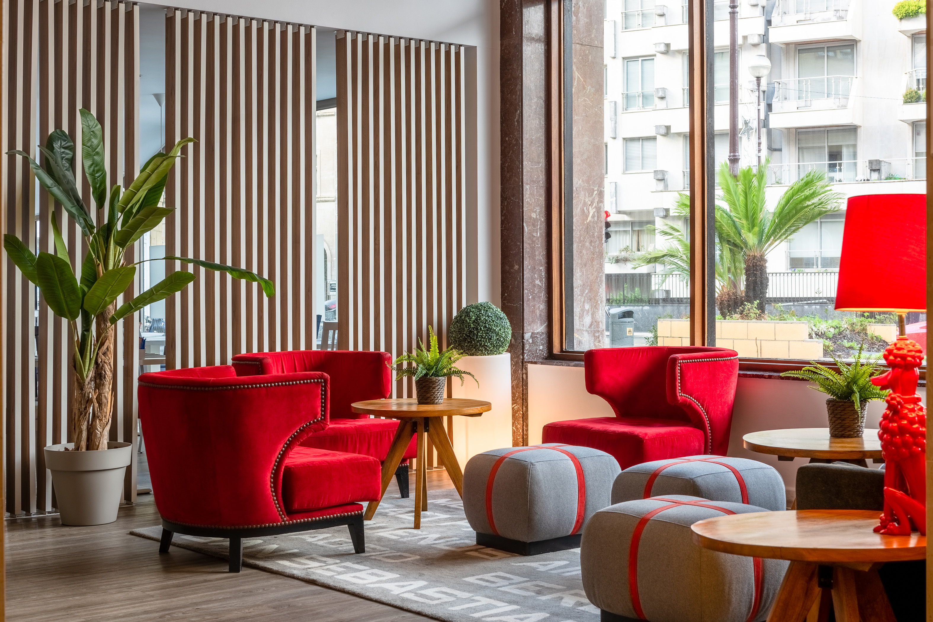 a room with red chairs and tables