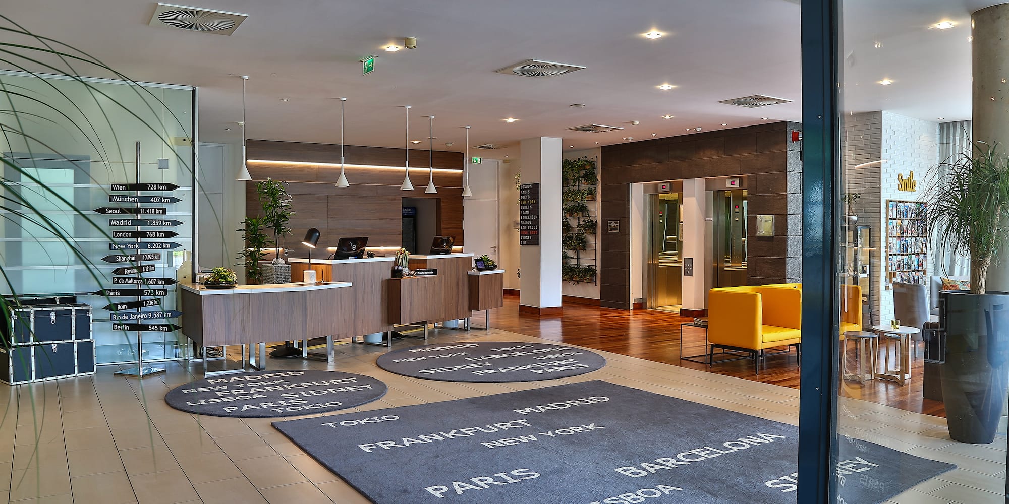 a lobby with a reception desk and a yellow chair