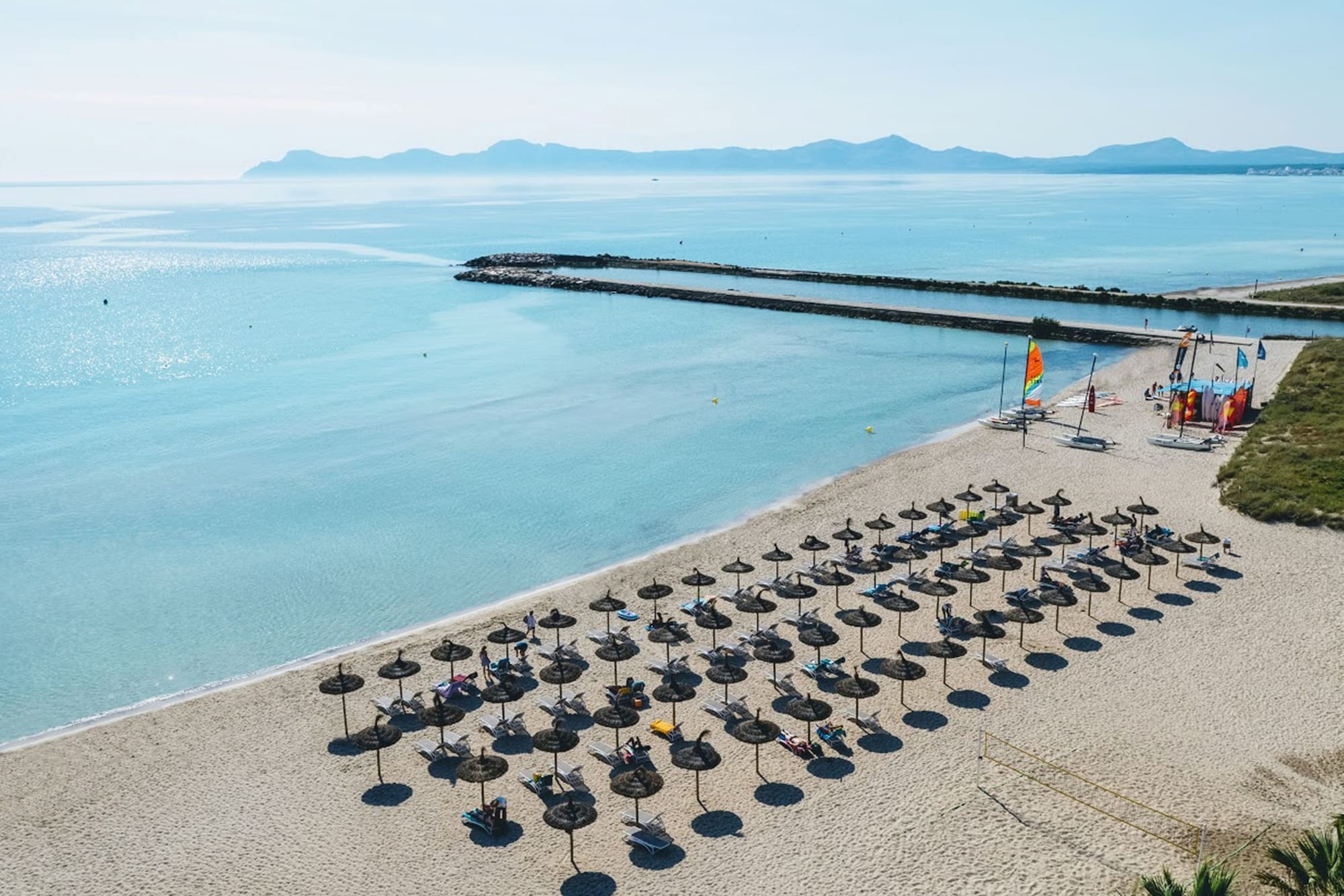 a beach with umbrellas and chairs