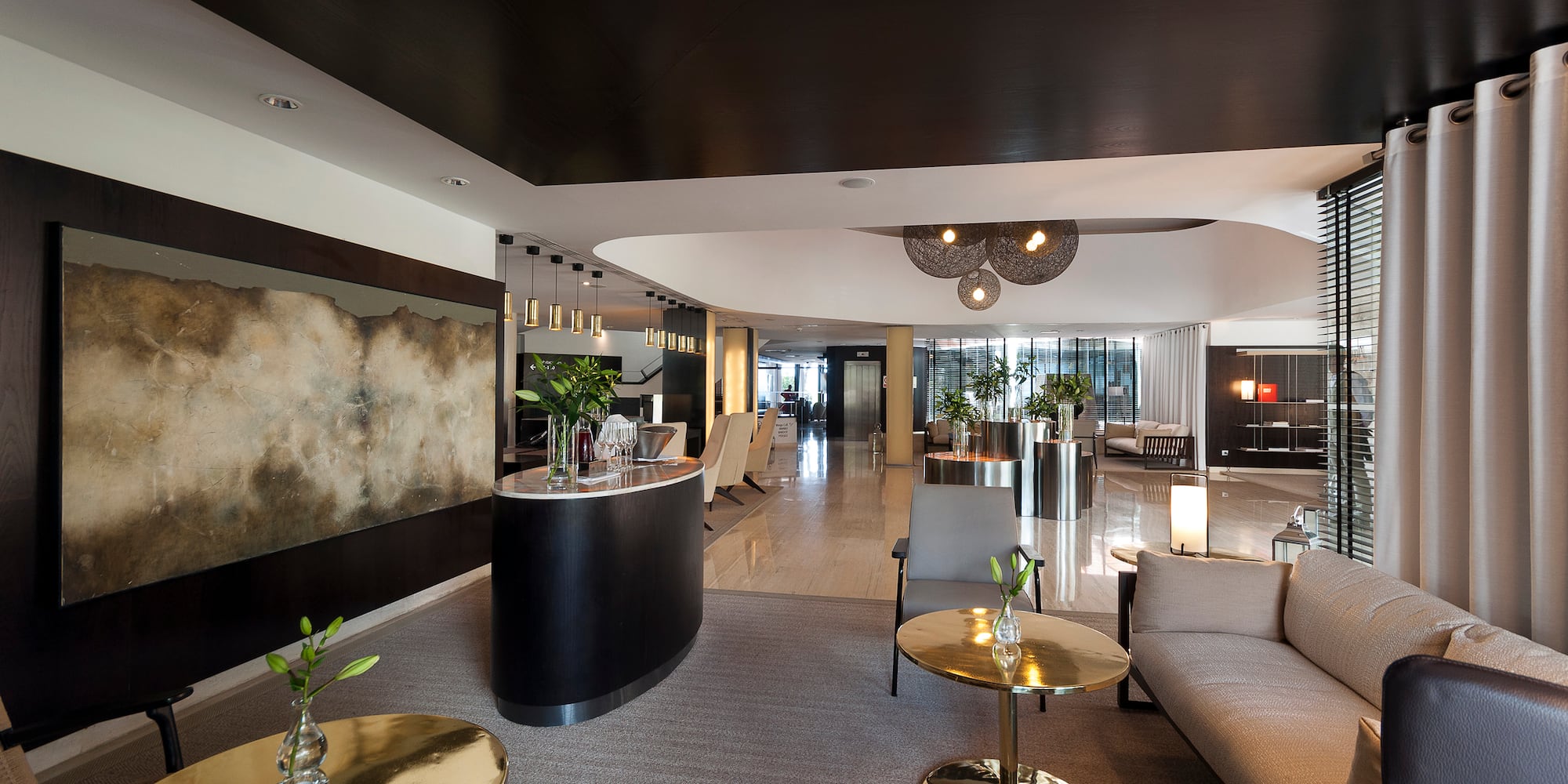 a lobby with a large round table and chairs