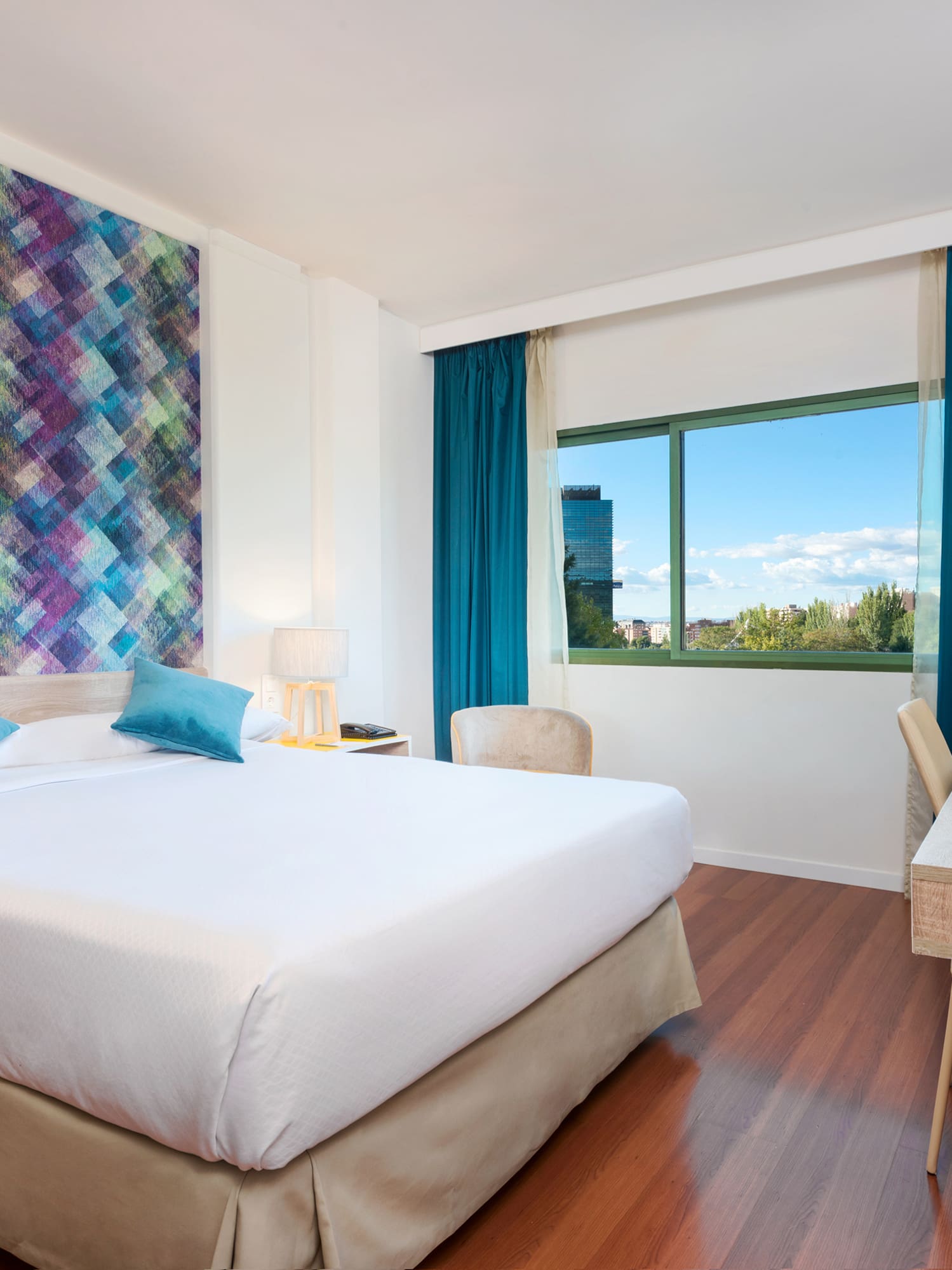 a room with a bed and a table and chairs