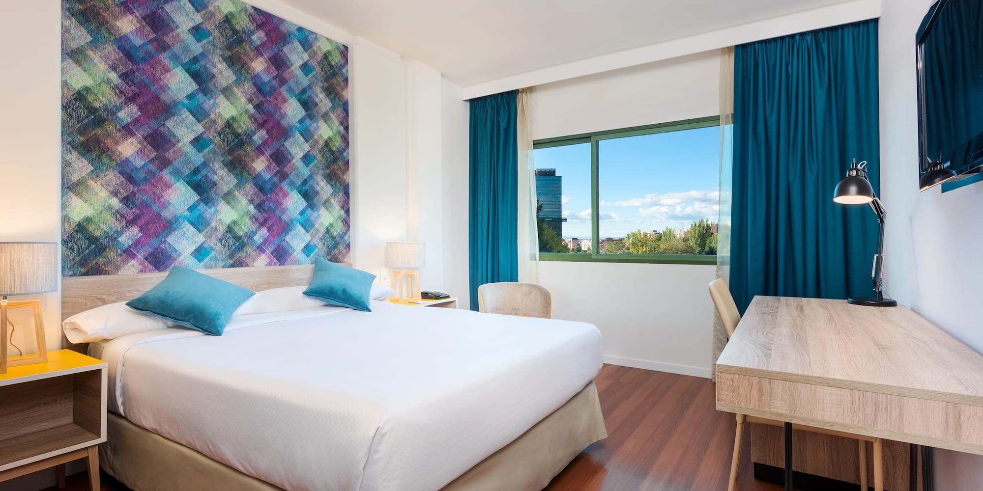 a room with a bed and a table and chairs