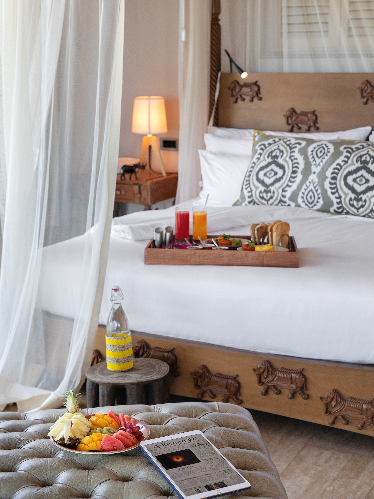 a tray of food on a bed