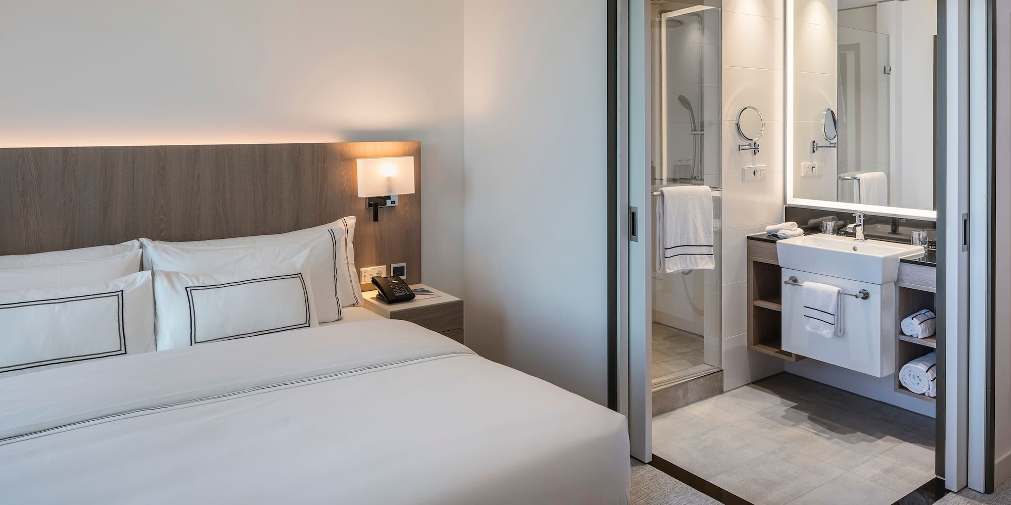 a hotel room with a bed and a shower