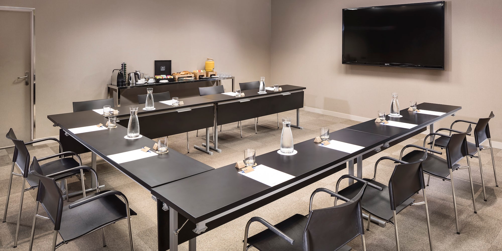 a room with black tables and chairs
